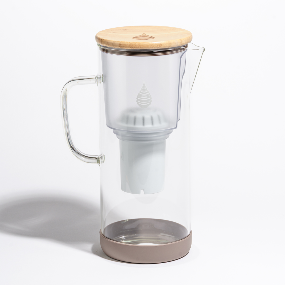 Clear glass Invigorated pH Restore pitcher with upper insert, internal cartridge holder, bamboo lid and silicone-colored base